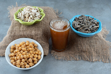 A colorful plates of sunflower seeds on sackcloth
