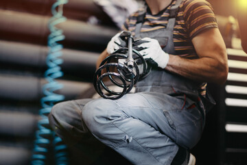 process of replacing the car suspension spring in a car service, replacing the spring and shock...