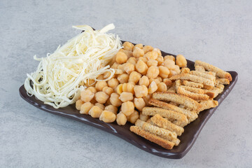 A lot of delicious food to the beer on black plates