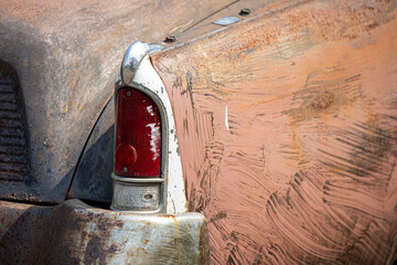 taillight and fender of an old rusty classic car