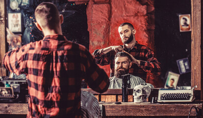 Man visiting hairstylist in barbershop. Bearded man in barbershop. Work in the barber shop. Man hairstylist