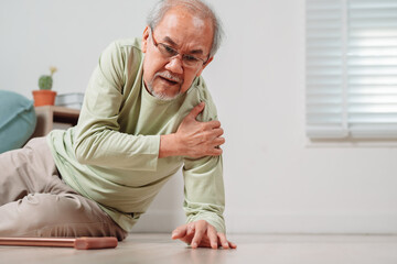 Asian senior man falling on the ground with walker in living room at home. Elderly older mature male having an accident heart attack for emergency help support from hospital. Insurance health care.
