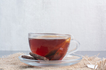 A cup of aroma tea with wooden spoon of infusion