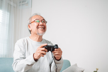 Asian Senior oider man family having fun enjoying play video game funny video using at home sit on sofa. Happiness lifestyle on retirement concepts.