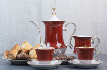 Two cups of aroma coffee with pastries on gray background
