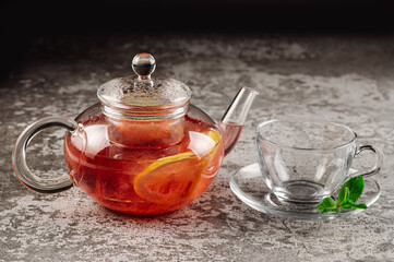 Tea from strawberry jam in a glass teapot