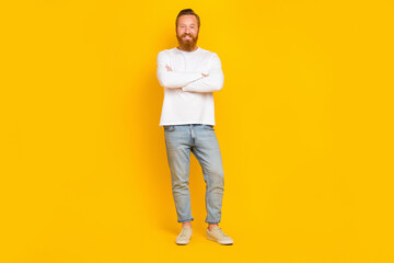 Fototapeta na wymiar Full length photo of cool beard man crossed arms wear white shirt jeans sneakers isolated on yellow color background