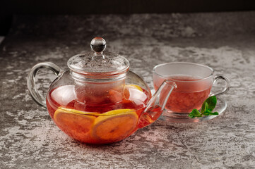 Tea from strawberry jam in a glass teapot