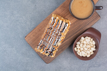 A piece of cake with cup of aroma coffee on gray background