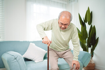 Asian Senior elderly old man disabled patient walking slowly his use walker or cane in living room...