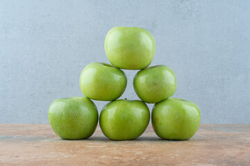 Green fresh sweet apples on marble background