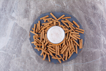 Crispy crackers with beer on wood piece