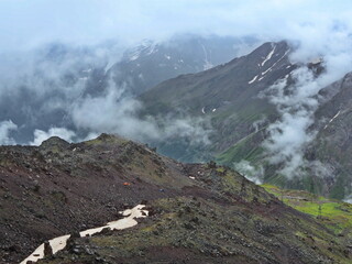 Mountain slopes of the Elbrus region with snow, glaciers and clouds. Elbrus region,...