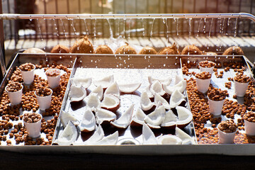 Stall selling coconuts and capers with falling water