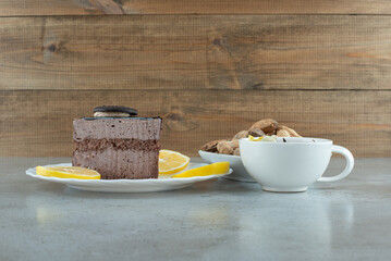 Slice of chocolate cake with tea and peanuts