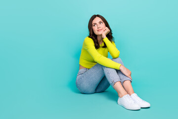 Full length portrait of minded lovely person sit floor hand touch cheek look empty space isolated...