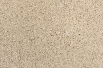 abstract background of an old shabby painted beige wall close up