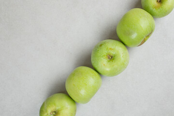 Whole green apples on gray background