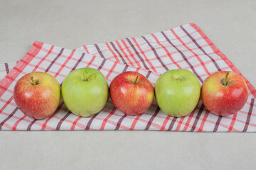Colorful fresh apples on striped tablecloth