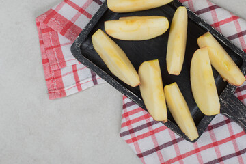 Slices of fresh red apple on black board