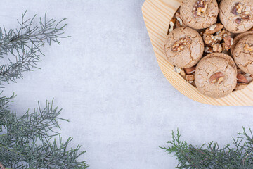 Fototapeta na wymiar Cookies with walnut kernels on wooden plate