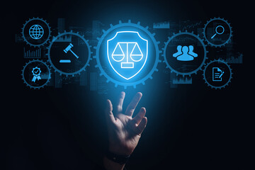 The concept of laws, court, legislation and jurisprudence. The hand projects a hologram with icons.