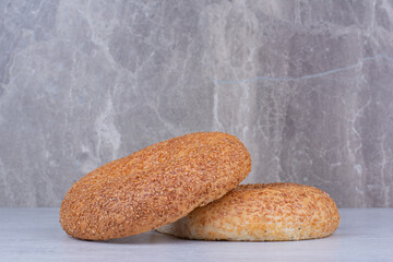 Turkish simits with sesame seeds on marble background