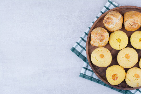 Two Kinds Of Cookies On Wooden Plate