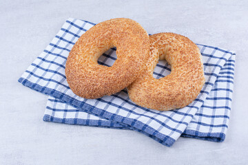 Turkish simits with sesame seeds on tablecloth