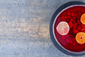 A dark pan of red juice on marble background