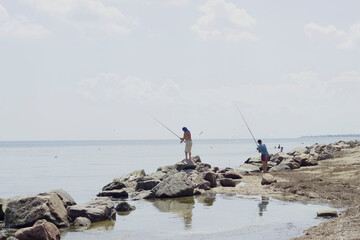 fishermen fishing with fishing rods on the sea catch fish