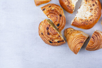 Half cut sweet pastries with cheese and raisins