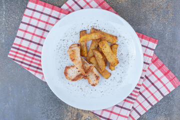 Roasted chicken and potatoes on white plate