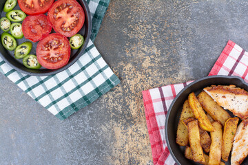 Roasted chicken and potatoes on pan with vegetable plate