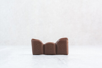 Piece of chocolate bar on stone background