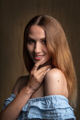 portrait of a young attractive woman on a dark background