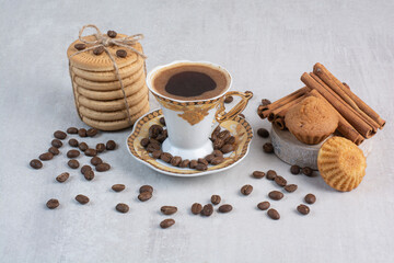 Obraz na płótnie Canvas Cup of coffee with various cookies and coffee beans