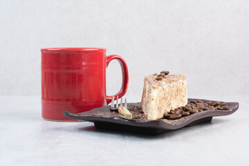 Slice of cake with coffee beans and cup of coffee