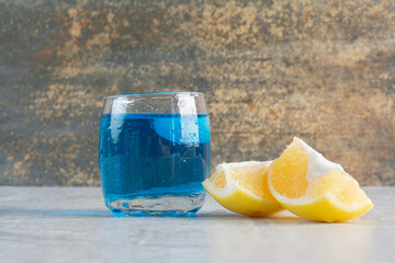 Delicious drink with slice of lemon on white background