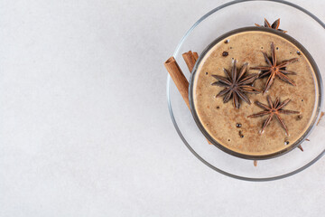 A cup of aroma tasty coffee with cinnamon sticks and star anise