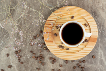 Coffee on wooden plate with coffee beans