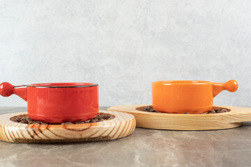 Two cups of coffee and coffee beans on wooden plates
