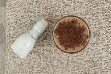 Cup of coffee and sugar on marble background