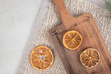 Dried orange slices on wooden board