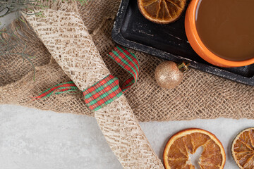 Coffee and orange slices on dark board with Christmas decoration
