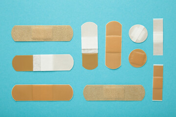 Set of adhesive plasters on blue background