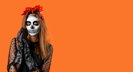Beautiful woman dressed as witch for Halloween on orange background with space for text
