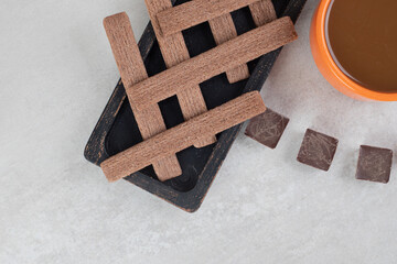 Coffee, biscuits and bitter chocolate on marble background