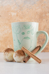 A cup of hot aroma coffee with cinnamon sticks on white background