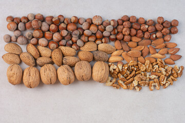 Mixed healthy nuts on marble background